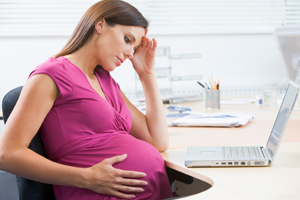 pregnant woman at her work desk