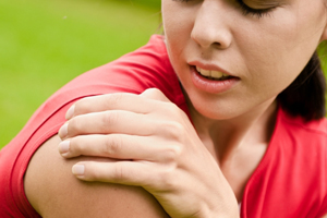 woman clutching painful shoulder