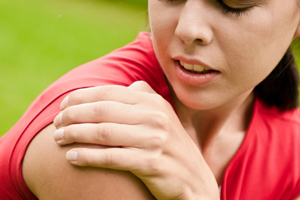 woman clutching painful shoulder